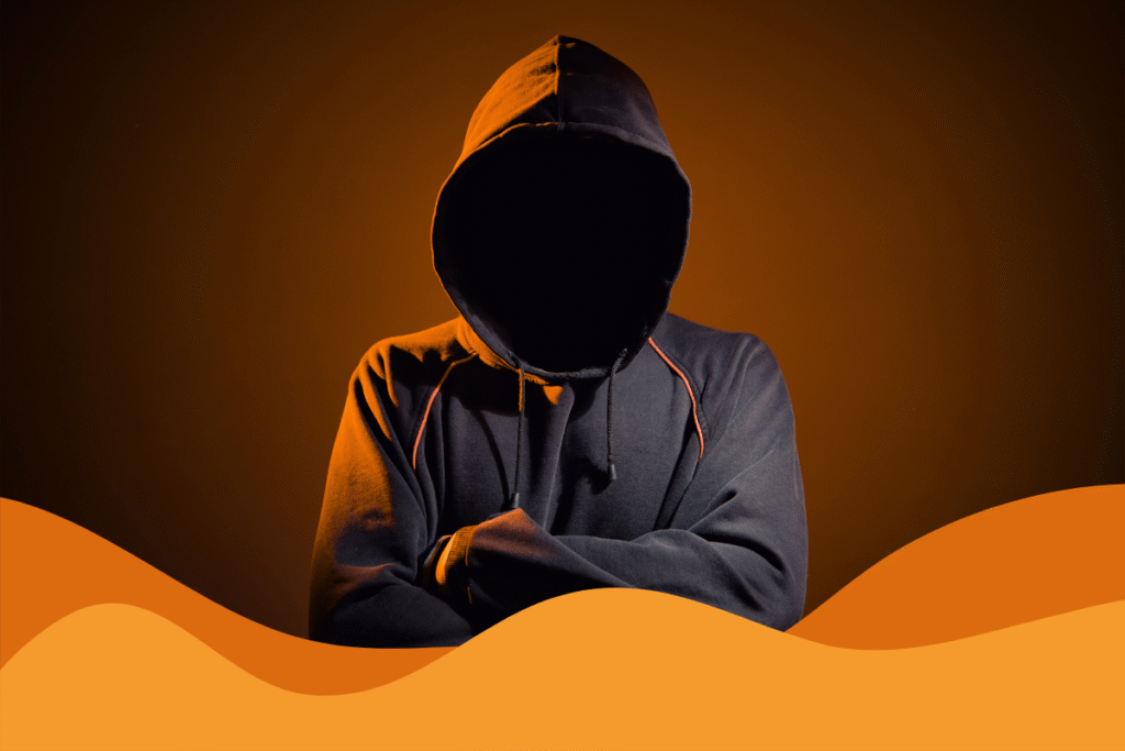 image of a hacker with hood up in the dark in an article about staying safe against hackers using AI this cybersecurity awareness month