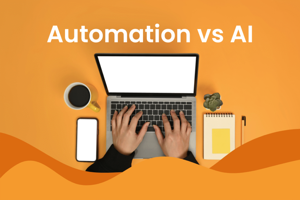 Person using a laptop with coffee and phone and notebook on side, with the screen and text "AI vs Automation" floating in front of the screen, in an article about the differences between AI and automation.