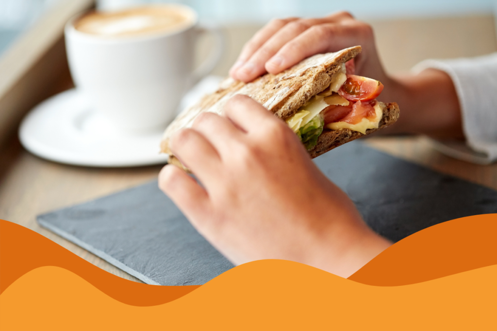 image of person eating a sandwich in an article about how ai is less regulated than sandwiches