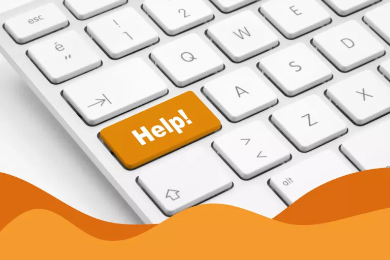 image of a white keyboard with an orange key saying Help! in an article about the differences between it support and managed it services