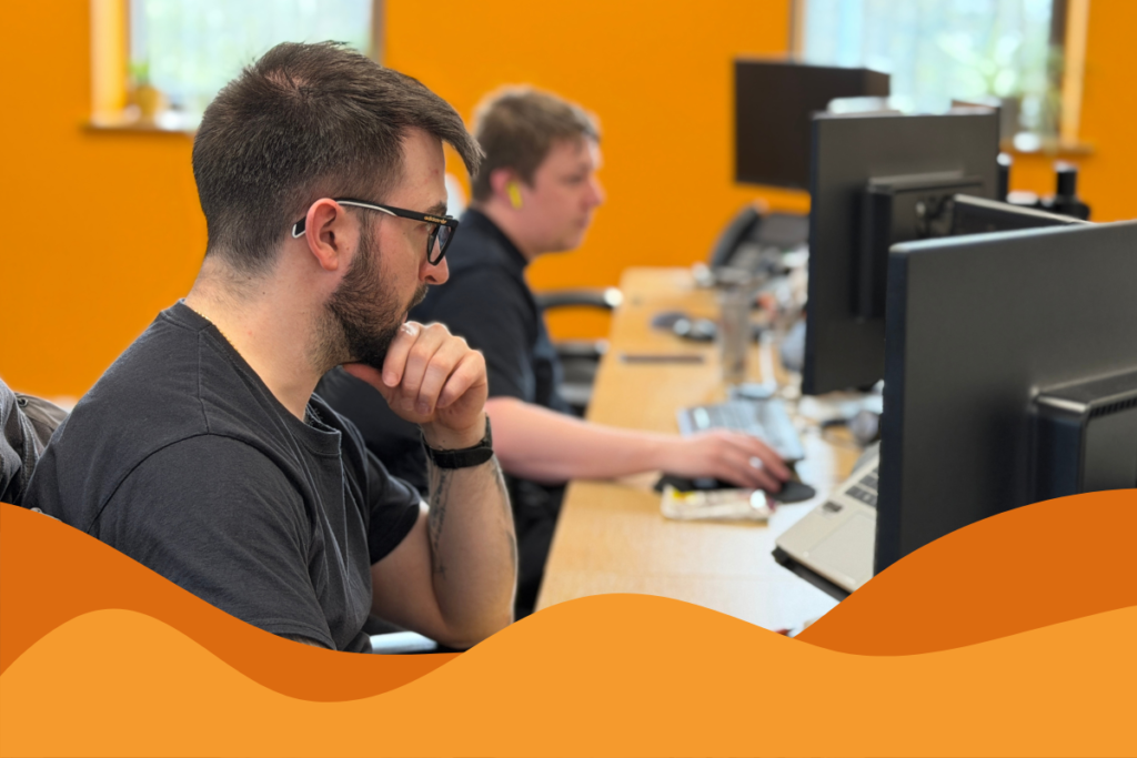 Image of two IT technicians at Daffodil IT working on their pcs in an article aboout AI and the importance of reputation in avoiding reputational damage to your small to medium business in Sheffield by Daffodil IT
