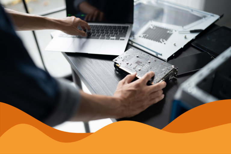 image of an it support technician fixing a MacBook on a grey desk in an article answering what is managed it support and how can SMEs in Sheffield benefit from an MSP by Daffodil IT in Sheffield, South Yorkshire serving customers across Sheffield, Chesterfield, and further.