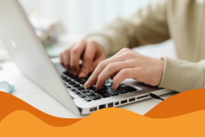 Image of a person using a MacBook against a white clear background and light airy lighting in an article about August cybersecurity news and what businesses should look out for by Daffodil IT in Sheffield, South Yorkshire.