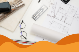 image of a table laid out with architecture papers, building designs and equipment in an article about it support for architecture firms by Daffodil IT in Sheffield, South Yorkshire.
