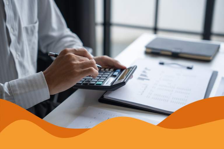 Image of a person using a calculator next to some documents in an office in an article of the true cost of downtime for Sheffield businesses seeking IT support by Daffodil IT in Sheffield, South Yorkshire.